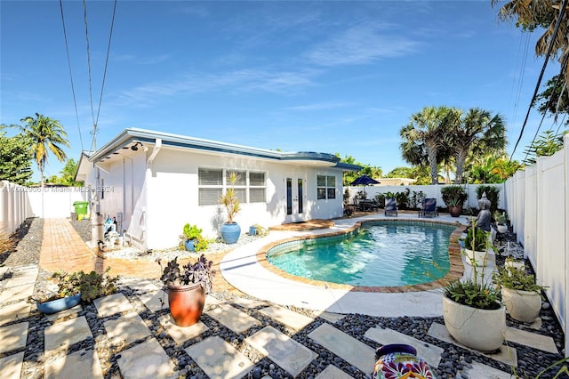 view of swimming pool featuring a patio and french doors