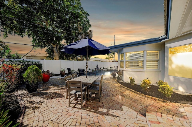 view of patio terrace at dusk