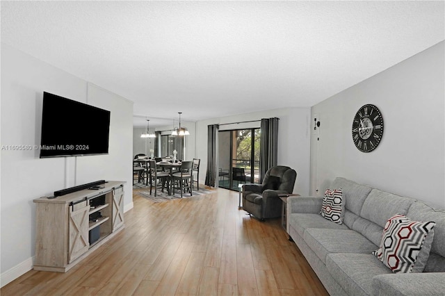 living room with light wood-type flooring and a textured ceiling