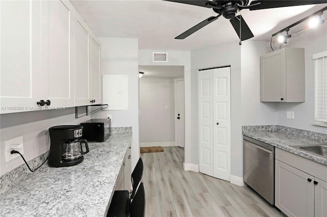 kitchen featuring light wood-type flooring, white cabinets, light stone counters, ceiling fan, and dishwasher