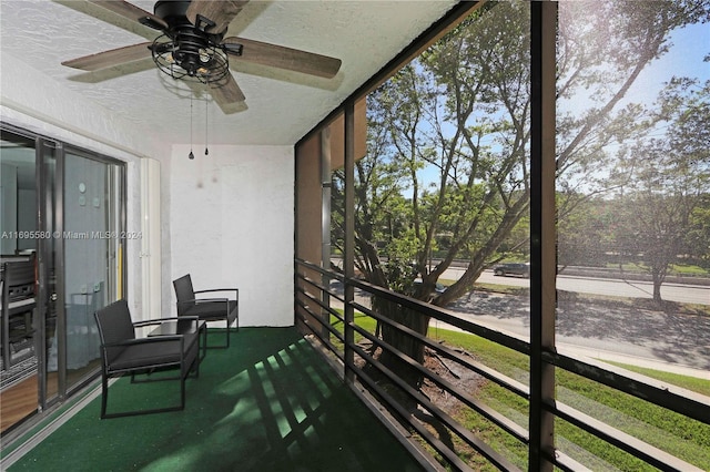 sunroom featuring ceiling fan and a healthy amount of sunlight