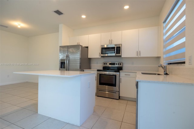 kitchen featuring white cabinets, a center island, sink, and appliances with stainless steel finishes