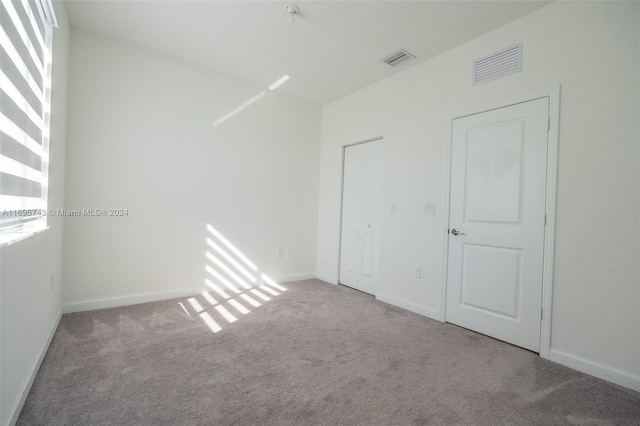 spare room with light carpet