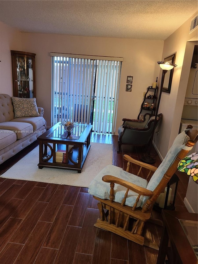 living room with hardwood / wood-style floors and a textured ceiling