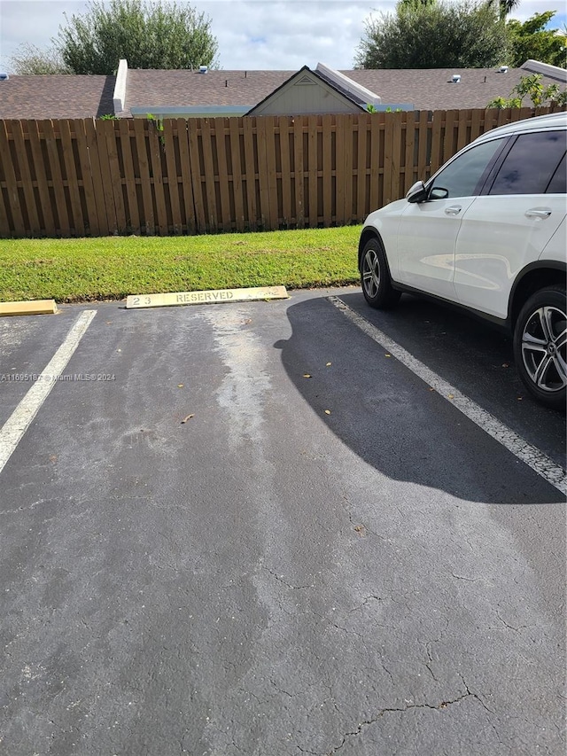 view of car parking featuring a lawn