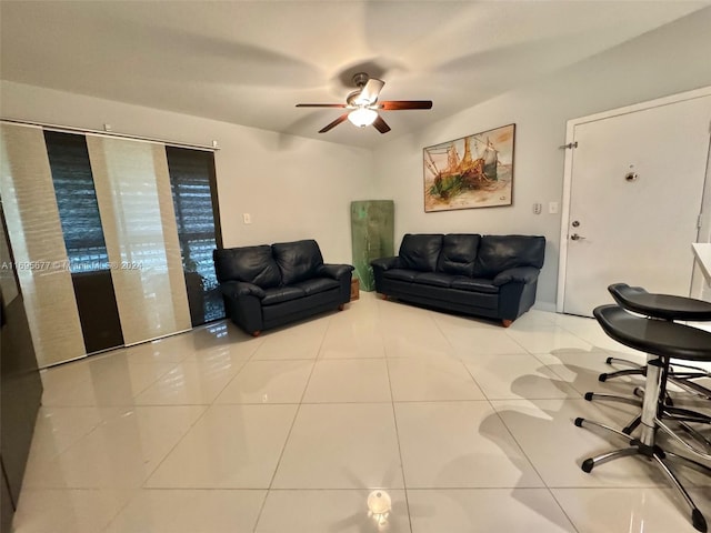 living room featuring ceiling fan and light tile patterned flooring