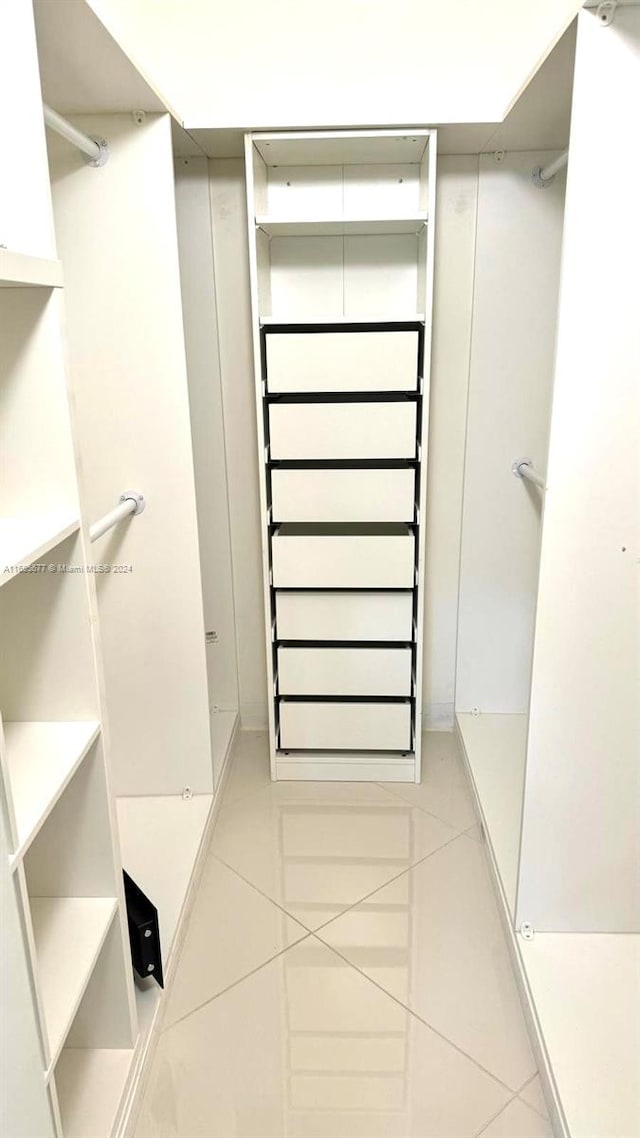 spacious closet featuring tile patterned flooring