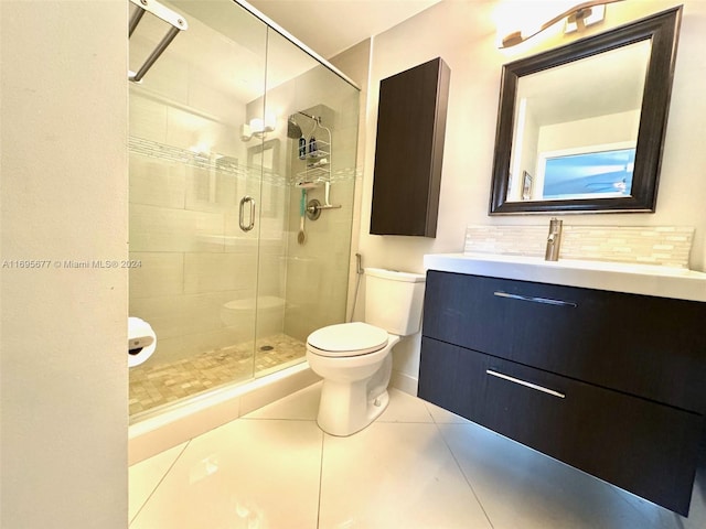 bathroom with vanity, backsplash, tile patterned floors, toilet, and walk in shower