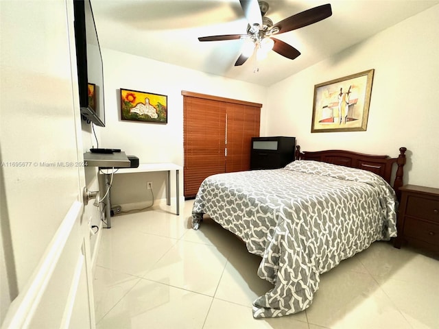 tiled bedroom with ceiling fan