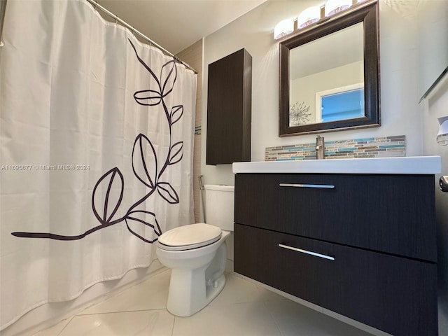 bathroom featuring tile patterned floors, vanity, and toilet