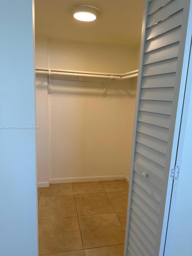 spacious closet with light tile patterned floors