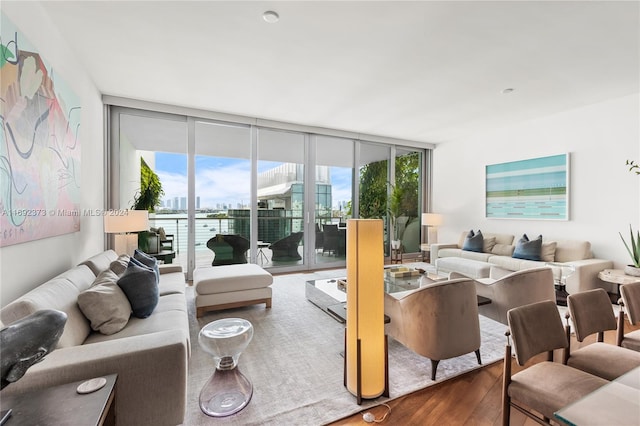 living room with floor to ceiling windows, a wealth of natural light, and hardwood / wood-style floors