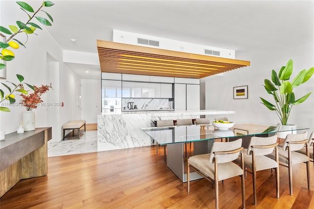 dining area with light hardwood / wood-style floors