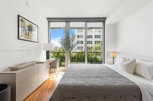 bedroom featuring light hardwood / wood-style floors and multiple windows