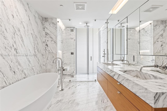 bathroom featuring shower with separate bathtub, vanity, and tile walls