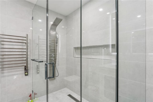 bathroom with an enclosed shower and radiator heating unit