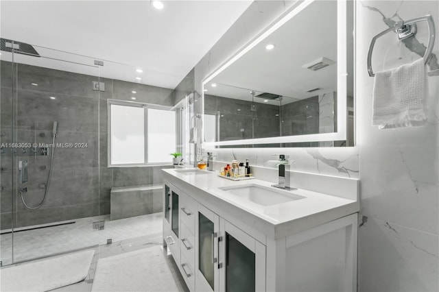 bathroom with vanity, an enclosed shower, tile walls, and tasteful backsplash