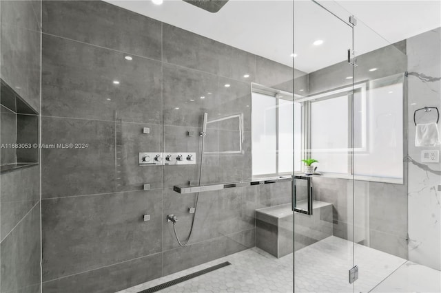 bathroom featuring tile walls and walk in shower