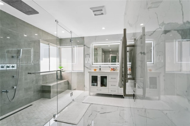 bathroom with vanity, walk in shower, and tile walls