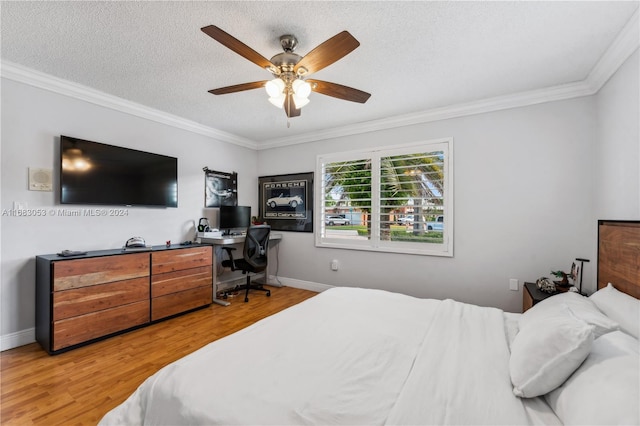 bedroom featuring a textured ceiling, ceiling fan, wood-type flooring, and crown molding