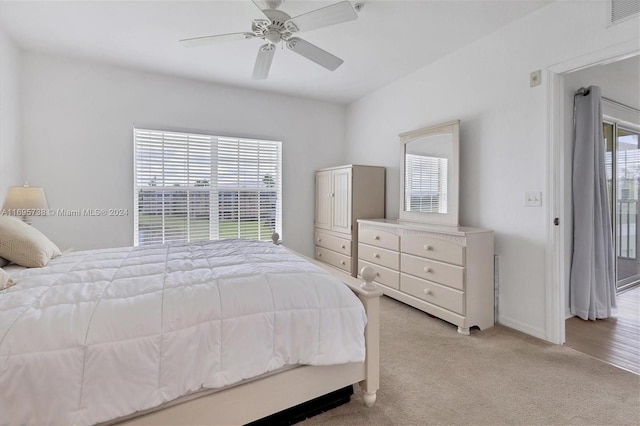 carpeted bedroom with multiple windows and ceiling fan