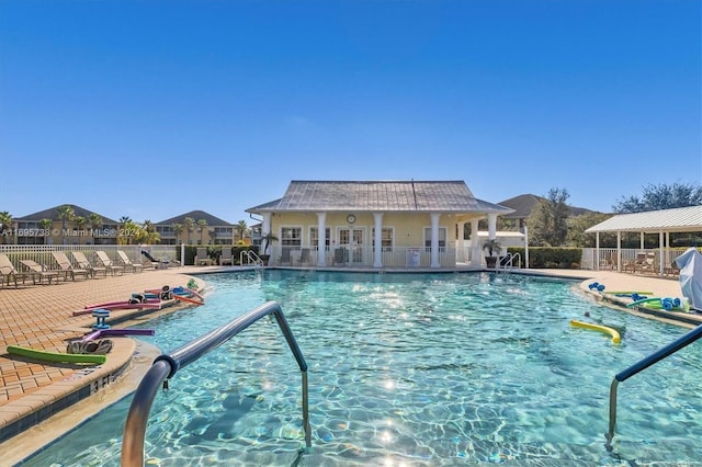 view of swimming pool with an outdoor structure and a patio