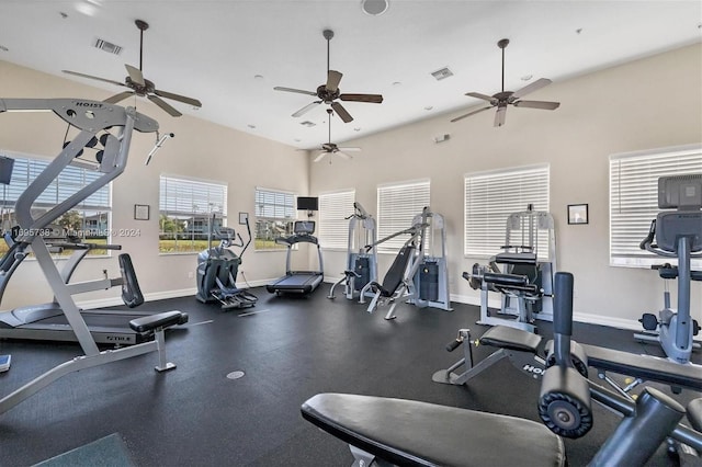 workout area featuring a towering ceiling