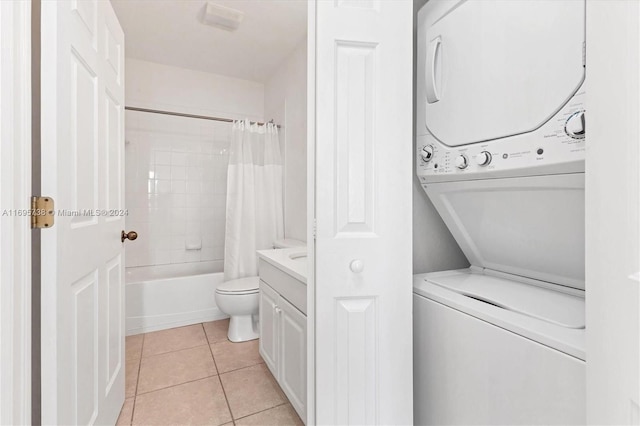 washroom featuring light tile patterned floors and stacked washer and dryer