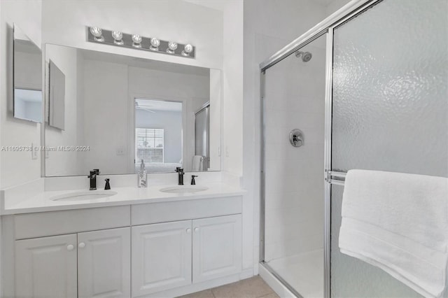 bathroom with tile patterned floors, vanity, and an enclosed shower