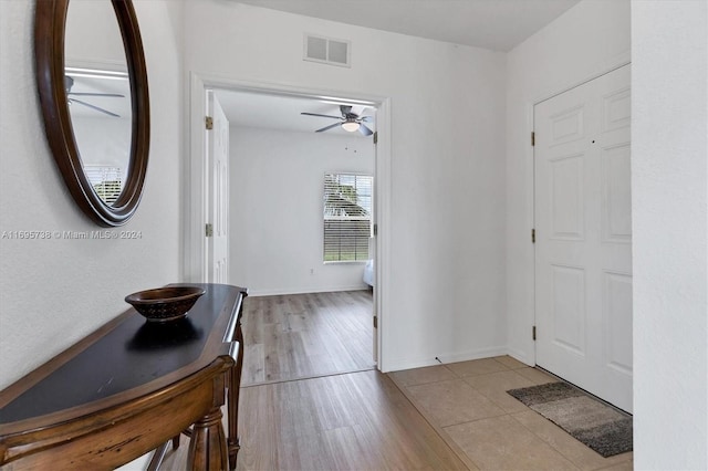 foyer featuring ceiling fan and light hardwood / wood-style floors