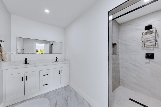 bathroom featuring a tile shower and vanity