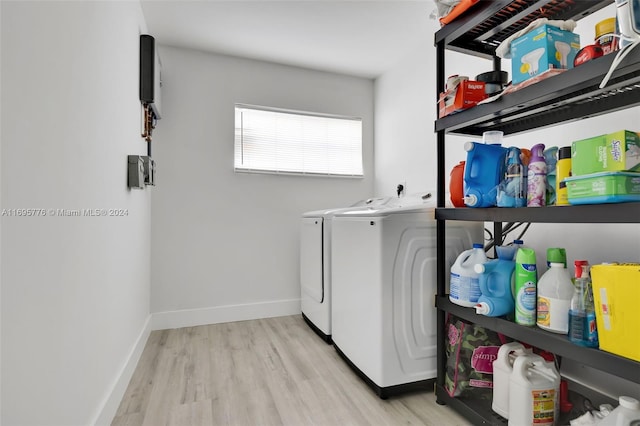 laundry room featuring light wood-type flooring and washing machine and clothes dryer