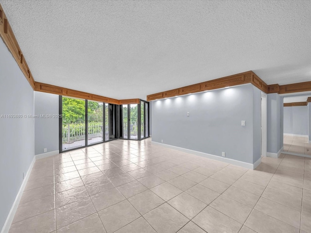 empty room featuring light tile patterned floors and expansive windows