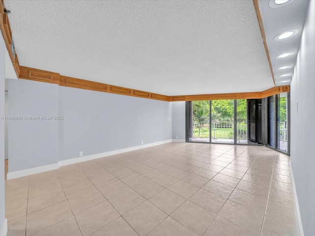 unfurnished room with expansive windows and light tile patterned floors