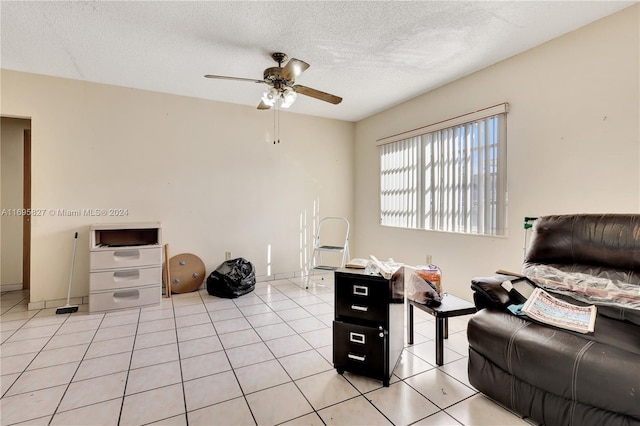 interior space featuring a textured ceiling, ceiling fan, and light tile patterned flooring