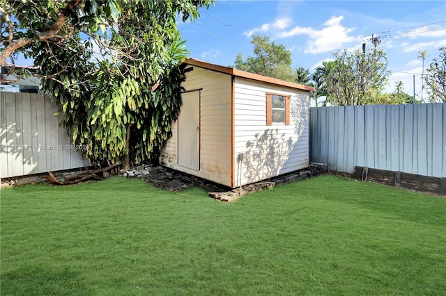 view of outdoor structure featuring a lawn