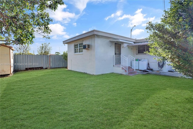 back of property featuring a yard and a wall mounted AC