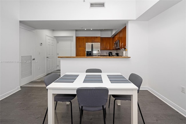 dining room with dark hardwood / wood-style floors