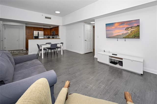 living room with dark hardwood / wood-style flooring