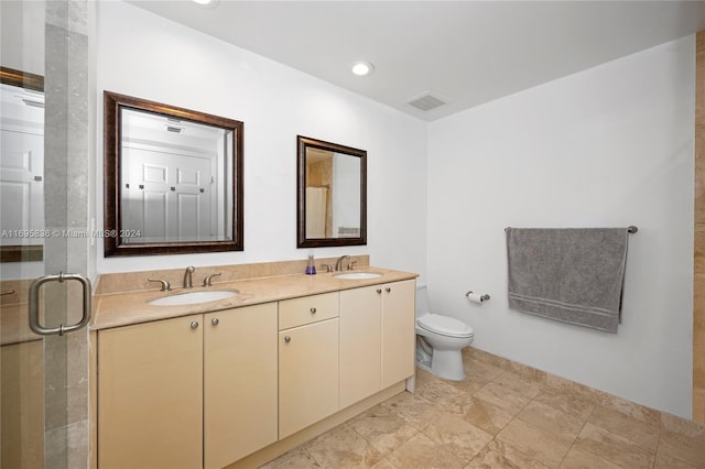 bathroom with vanity, toilet, and walk in shower