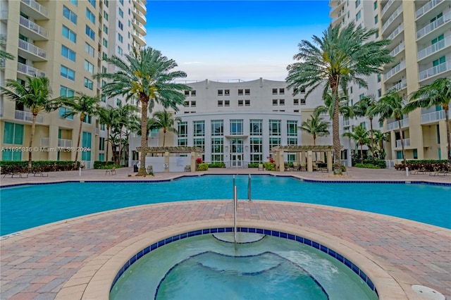 view of pool featuring a community hot tub and a pergola