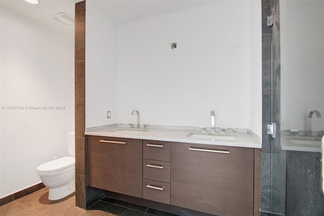 bathroom featuring tile patterned flooring, vanity, and toilet