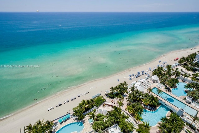 birds eye view of property featuring a beach view and a water view