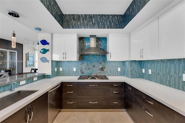 kitchen with white cabinets, wall chimney exhaust hood, stainless steel appliances, and light tile patterned floors