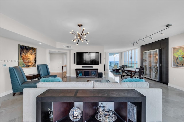 living room with rail lighting and a chandelier