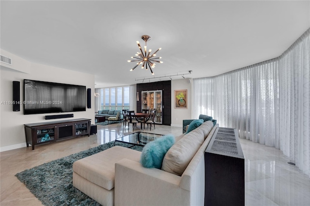 living room featuring an inviting chandelier and track lighting