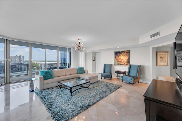 living room featuring floor to ceiling windows and a notable chandelier