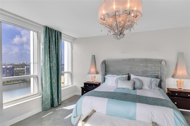 carpeted bedroom with a notable chandelier