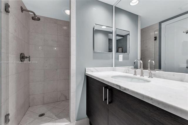 bathroom with tile patterned flooring, vanity, and a shower with shower door