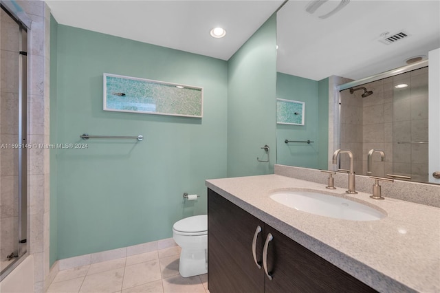 bathroom with tile patterned floors, vanity, toilet, and walk in shower